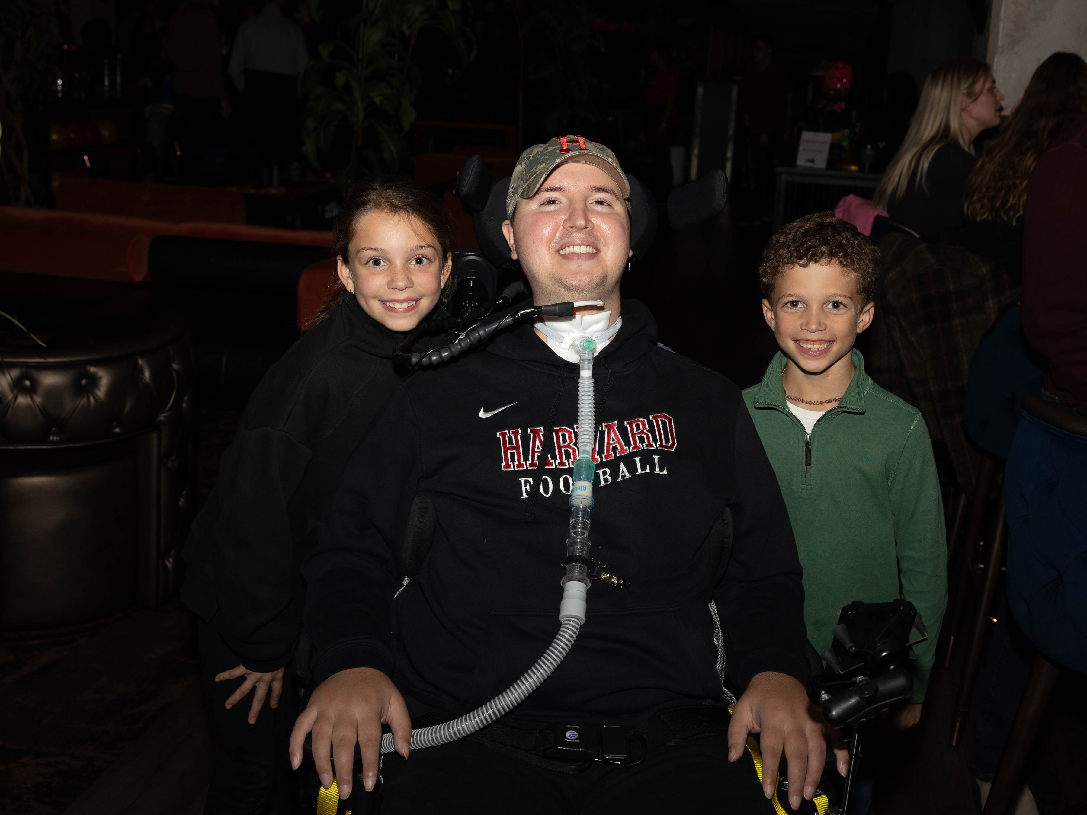 Ben with two young supporters at an event